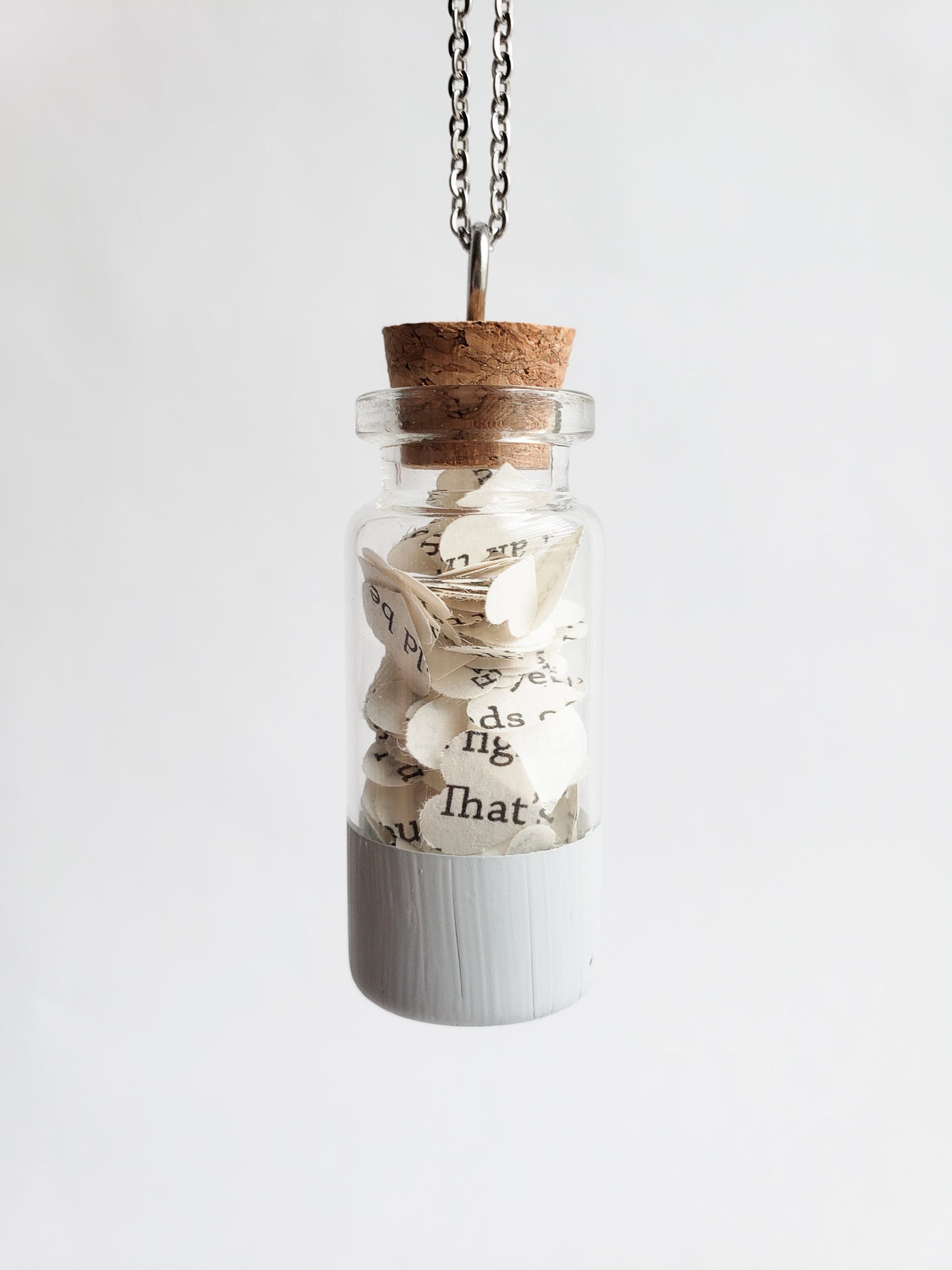 A small jar necklace with heart cut outs of book pages inside - Novel Blossoms Co