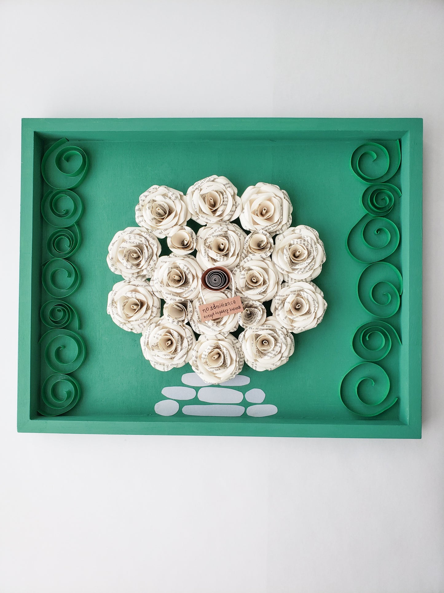 a framed round door made of book page paper flowers - Novel Blossoms Co