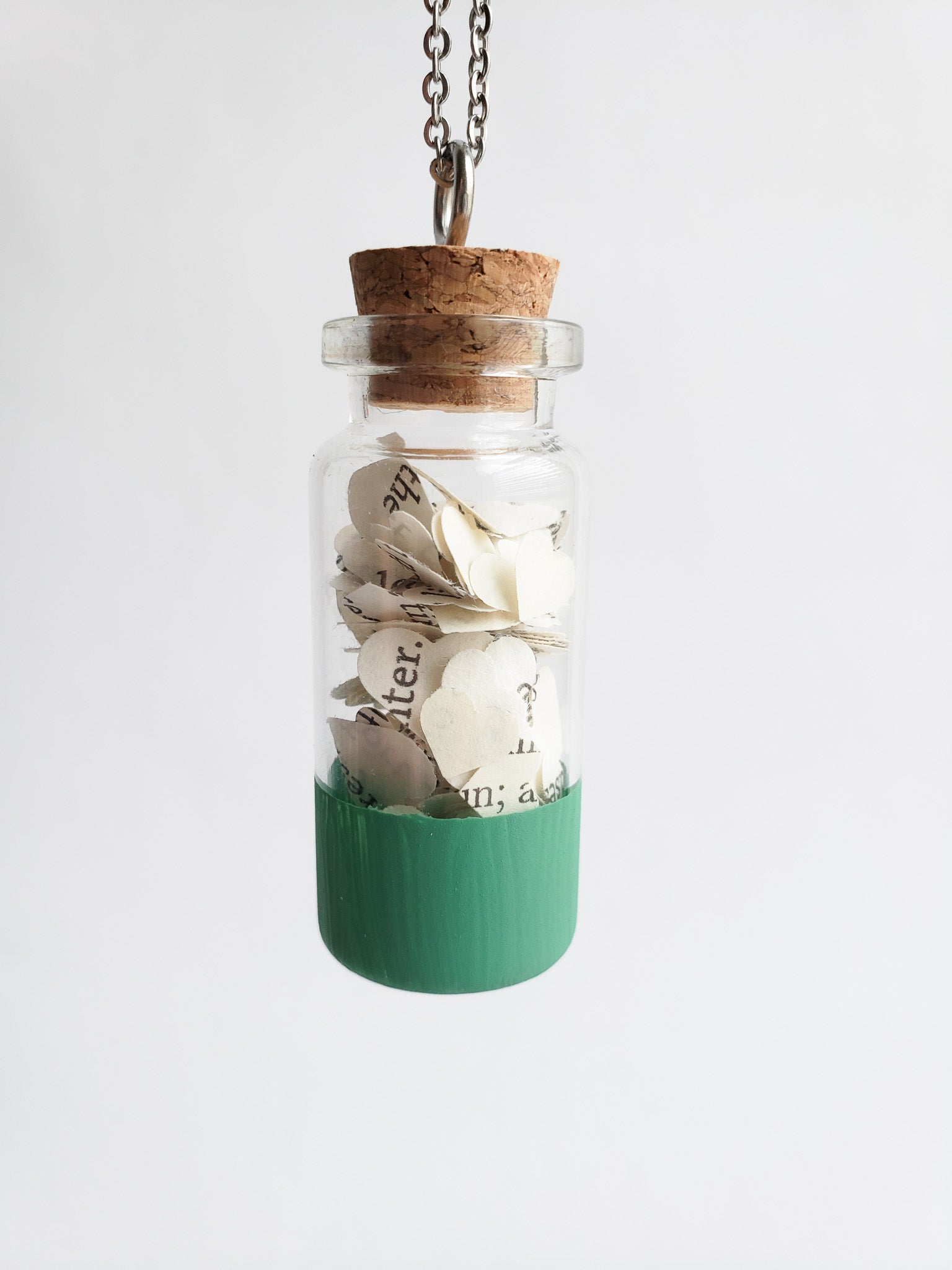 A small jar necklace with heart cut outs of book pages inside - Novel Blossoms Co