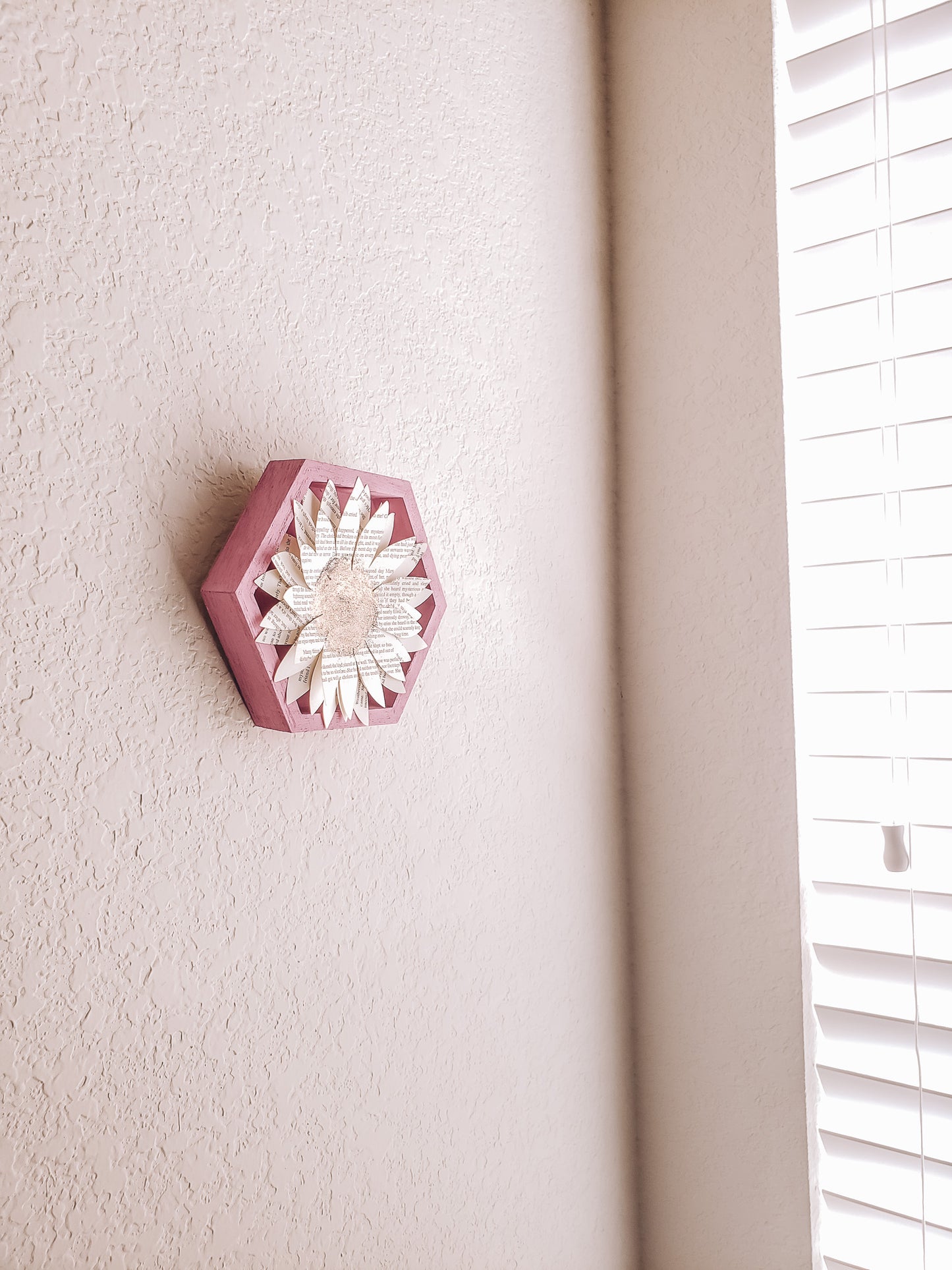 A book page paper sunflower in a hexagonal frame on a wall - Novel Blossoms Co