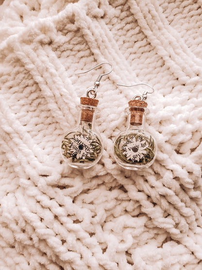 paper book page flowers in tiny glass jar earrings on top of a cozy blanket - Novel Blossoms Co