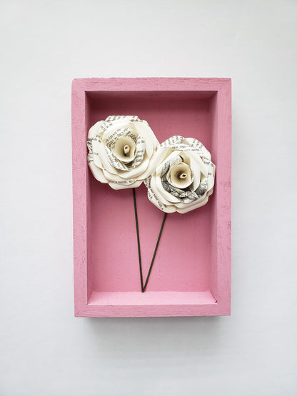 a pair of book page paper roses in a portrait shaped frame - Novel Blossoms Co